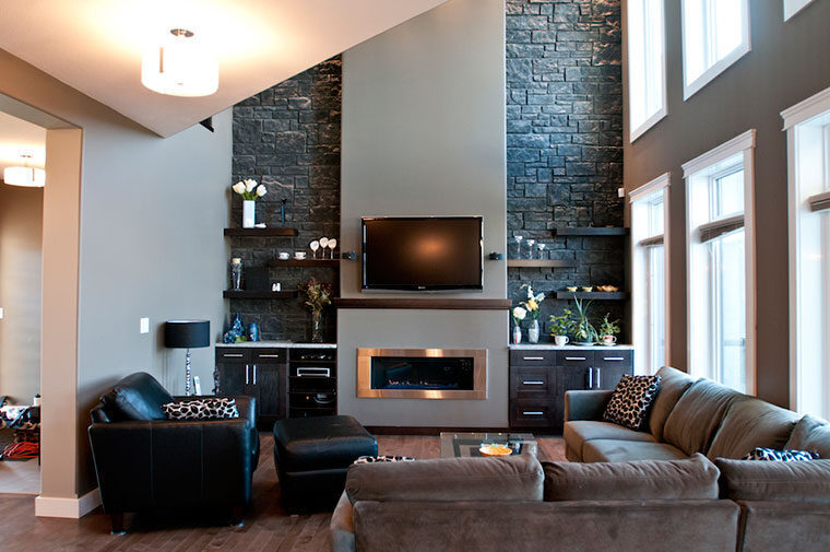 Living room with a stone fireplace and custom built-ins