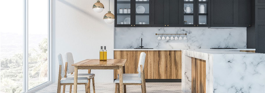 Kitchen with dark upper cabinets and a marble island