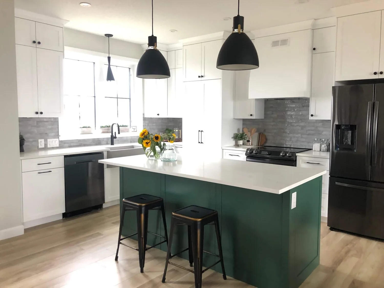 Green kitchen island with bar stools