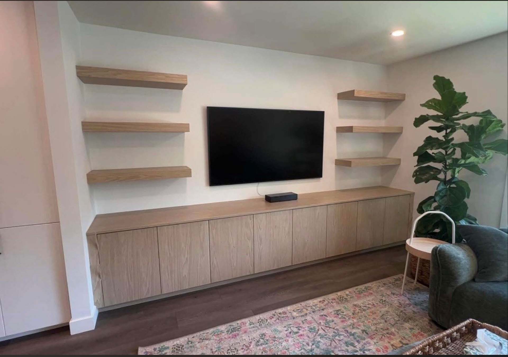 Media wall with floating shelves and lower cabinets