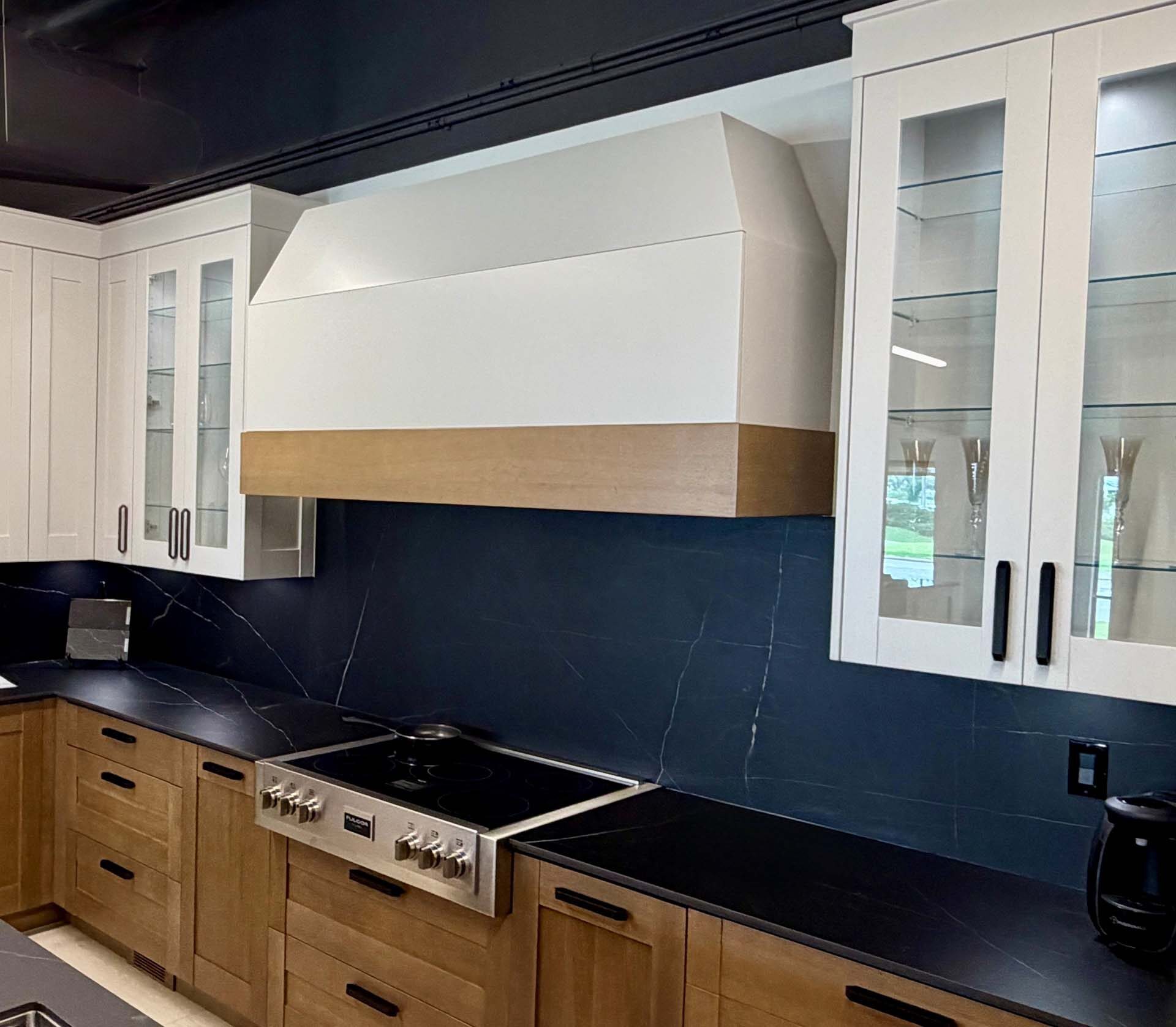 Navy kitchen with a custom range hood