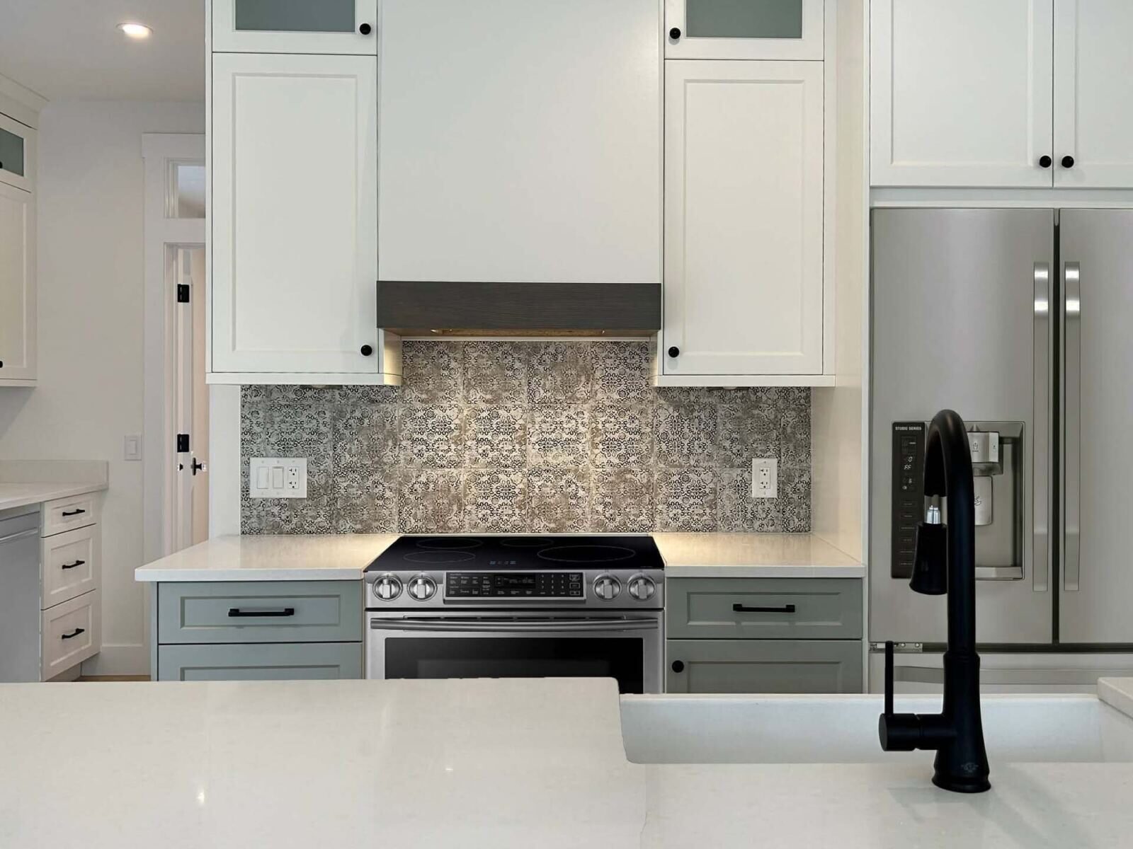 Matte black gooseneck faucet in a bright custom kitchen