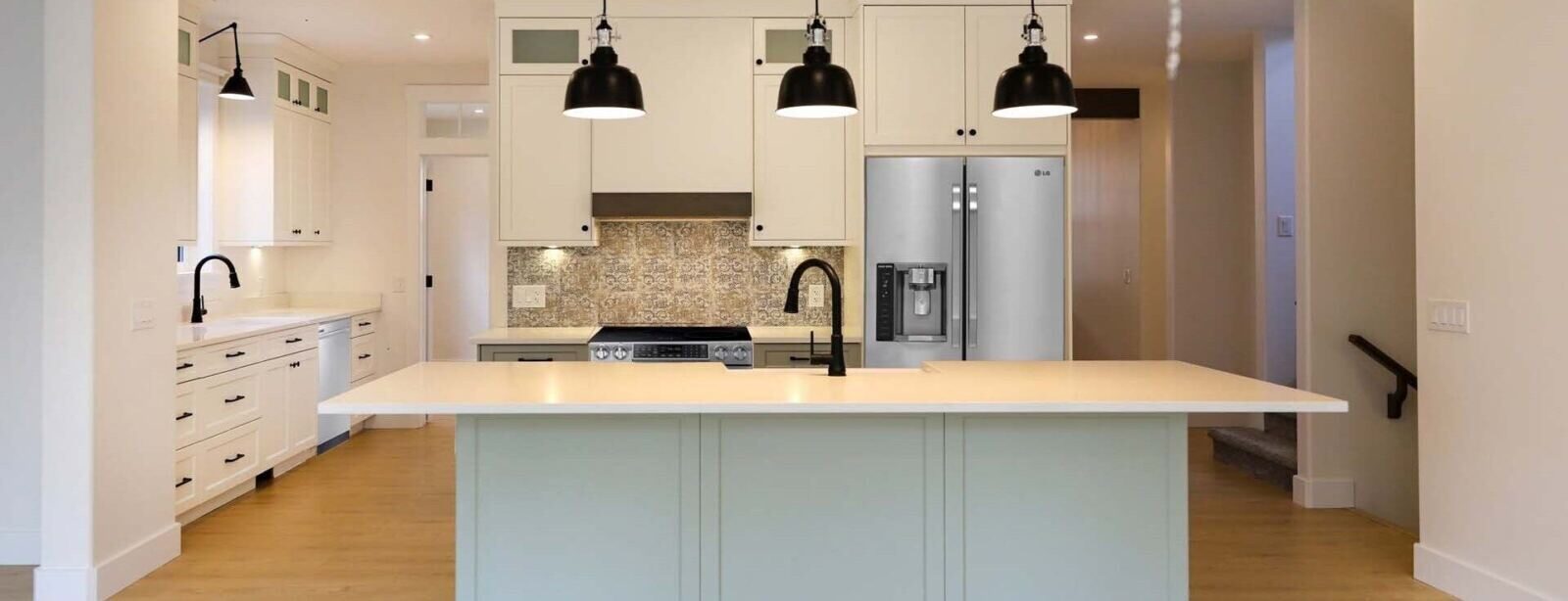 Kitchen island with black gooseneck faucet and pendant lighting, Evoke Cabinets Saskatoon