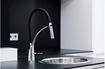 Black and chrome pull-down faucet over a stainless sink