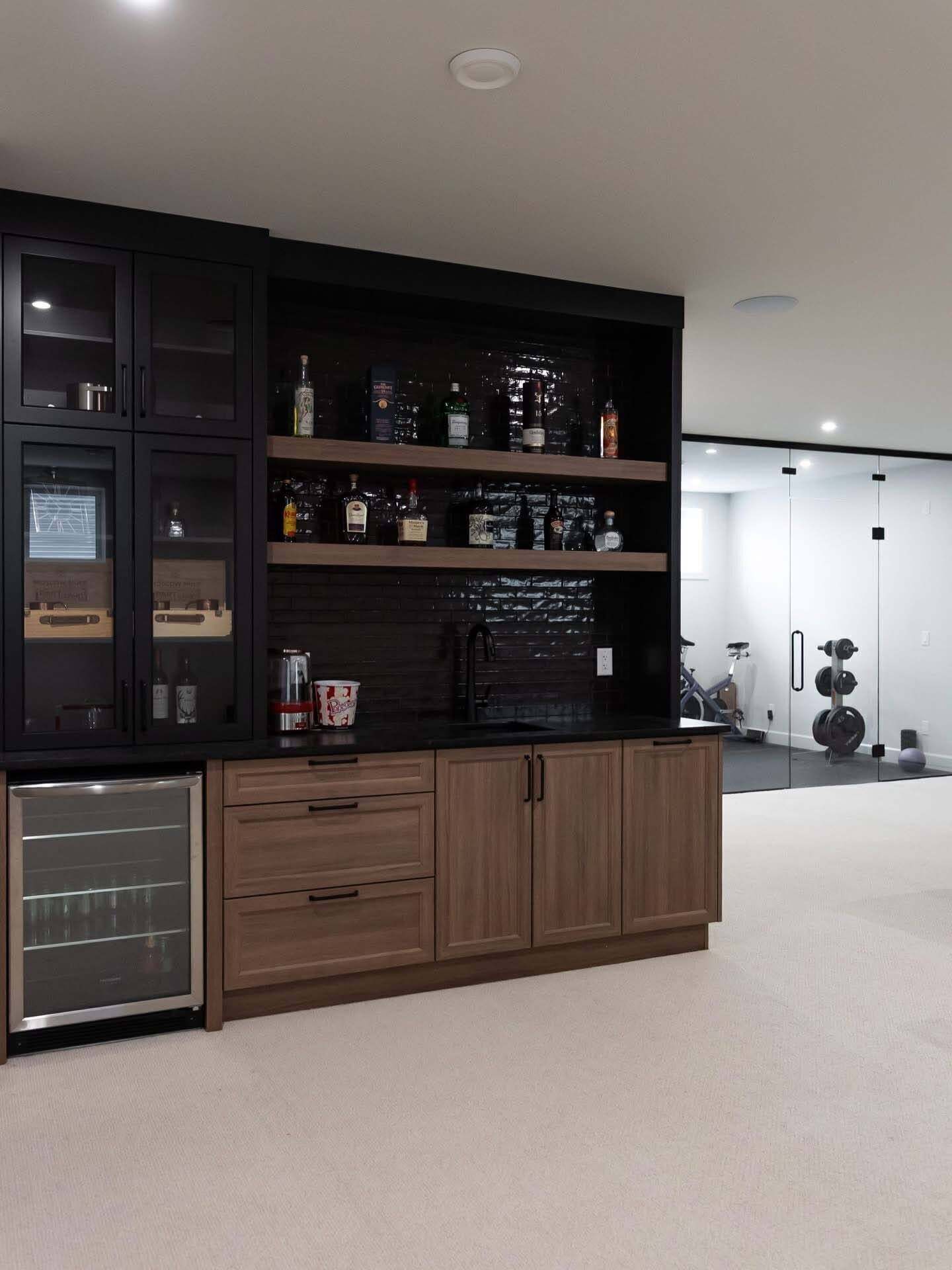 Dark bar cabinetry with wine fridge and display shelving
