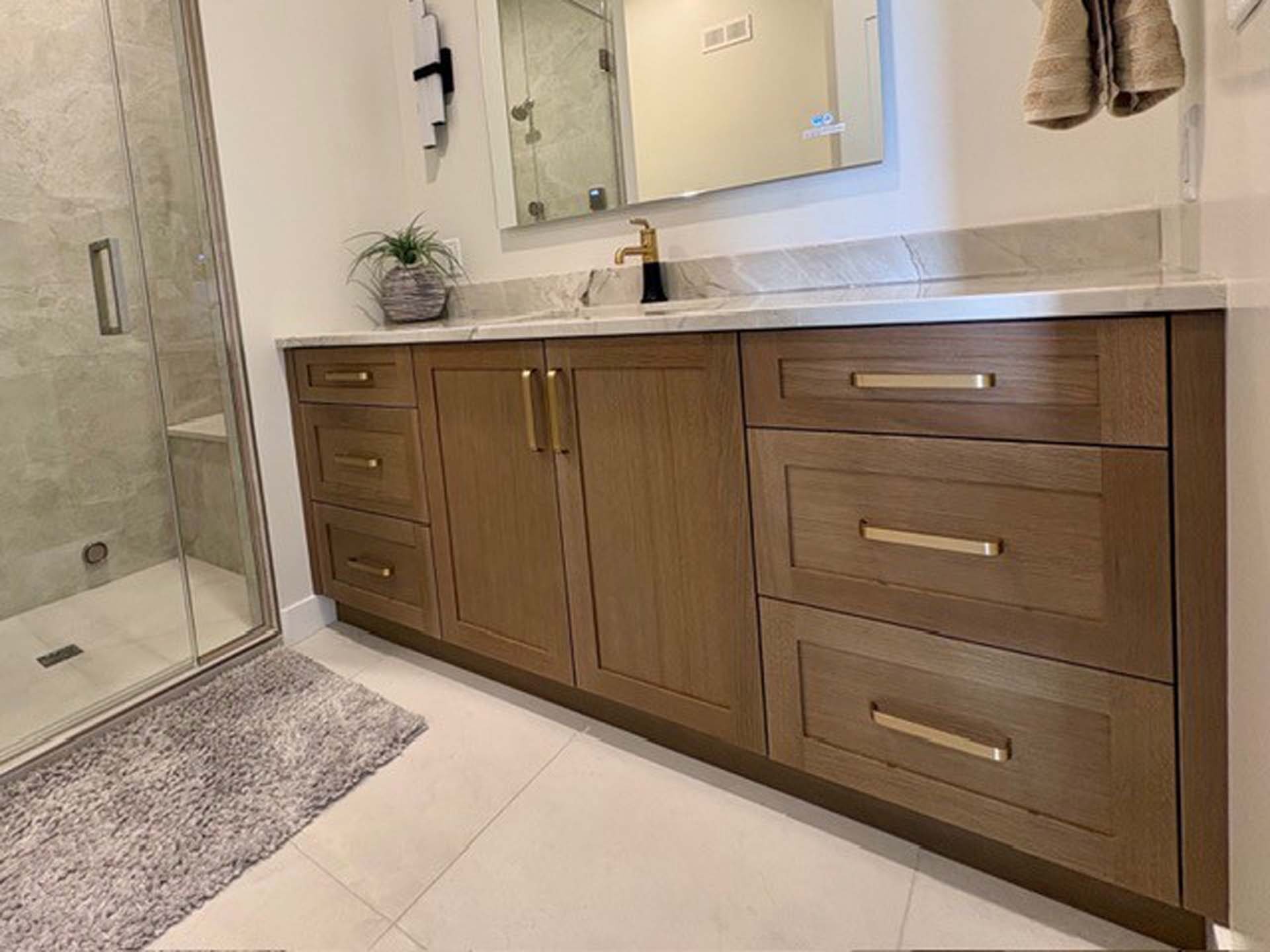 Wide custom double vanity in warm wood