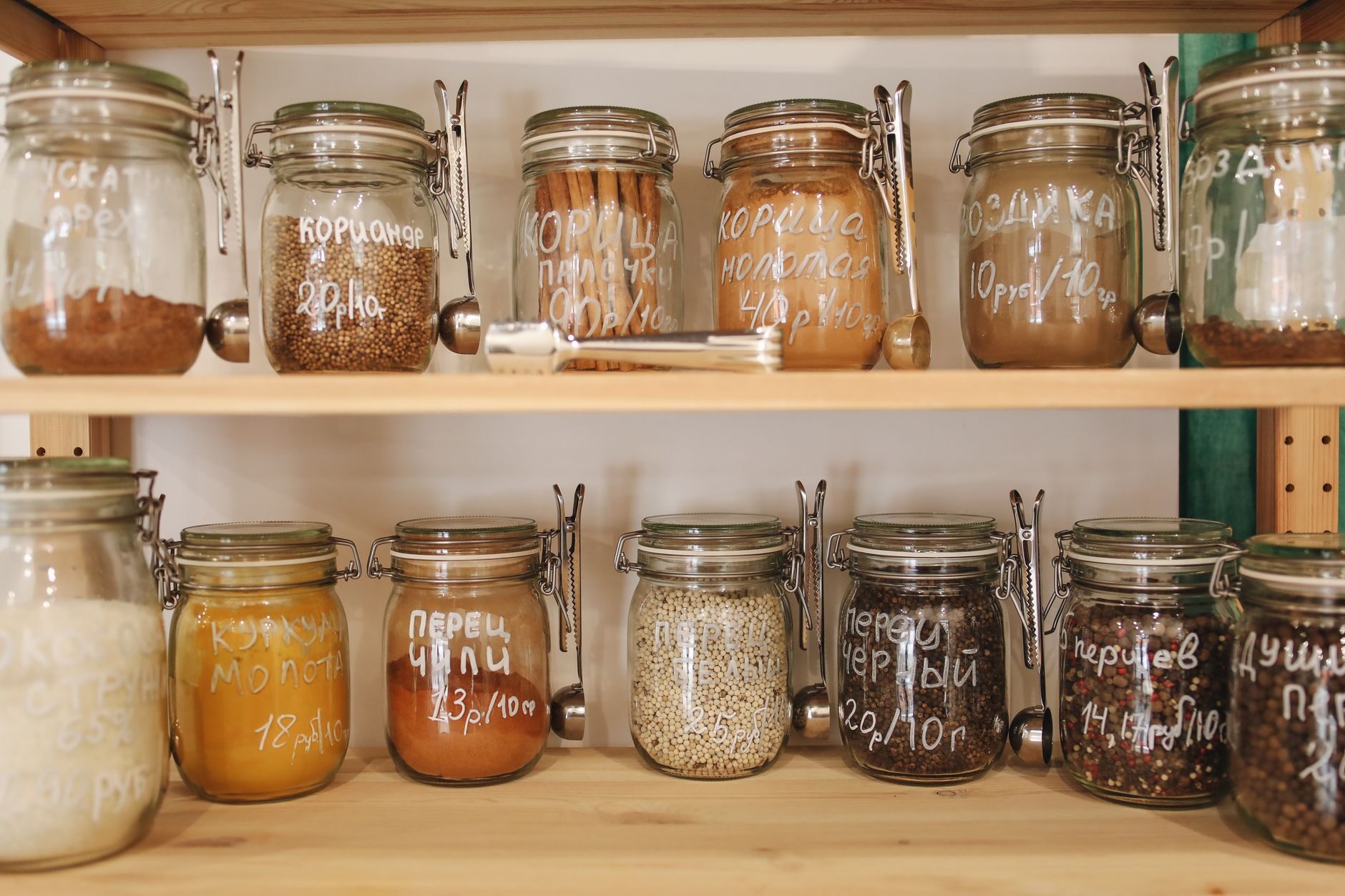 Labelled glass jars on open pantry shelving