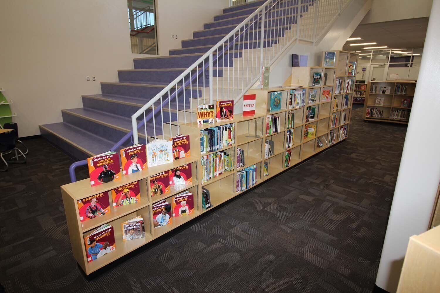 Under-stair book display shelving in a public library