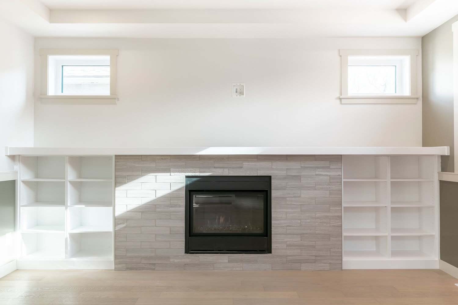 Fireplace with white built-in bookshelves