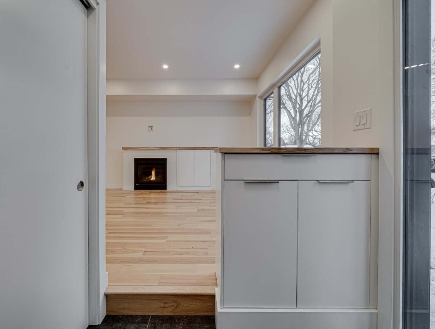 Fireplace beyond a custom entry step