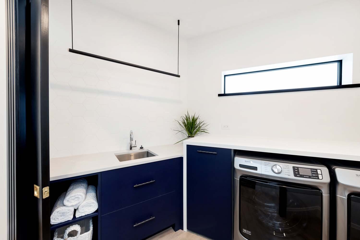 Custom navy laundry room cabinetry