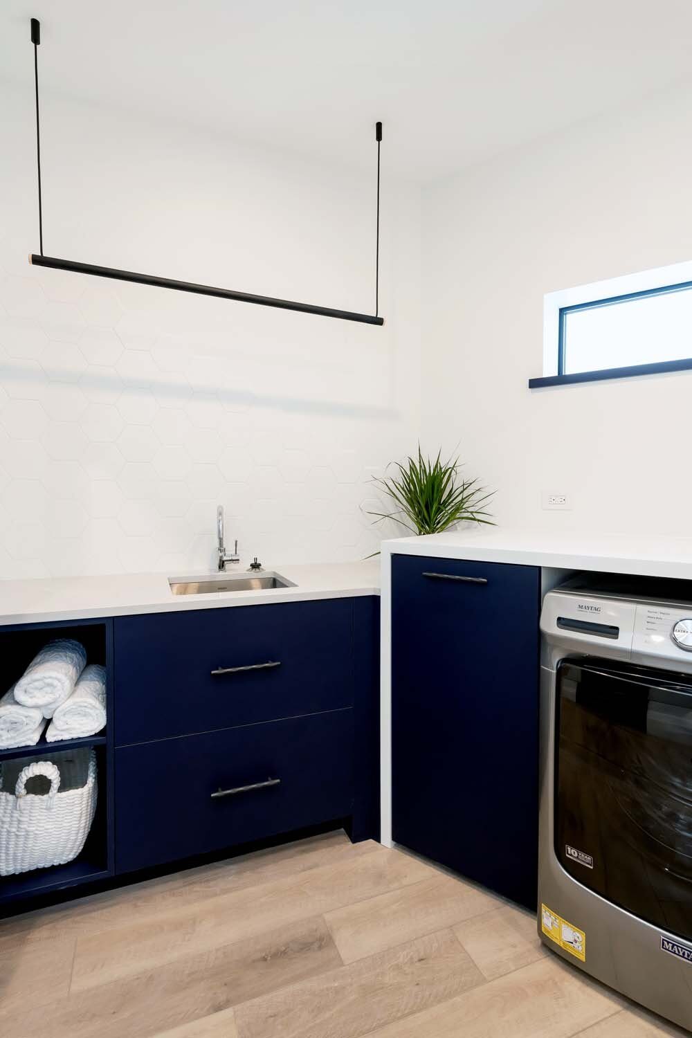 Custom navy laundry room cabinetry