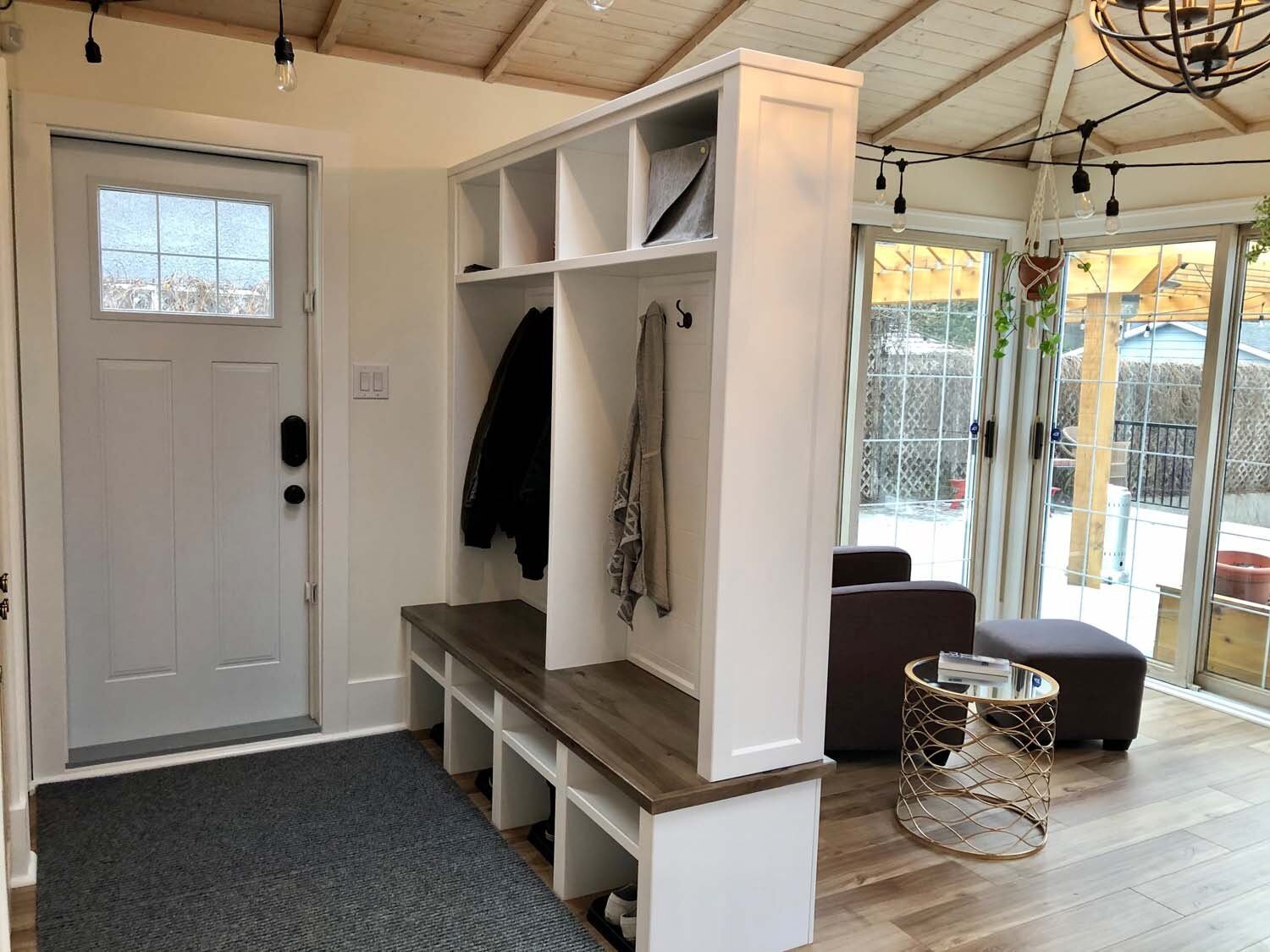 White mudroom with hooks and baskets