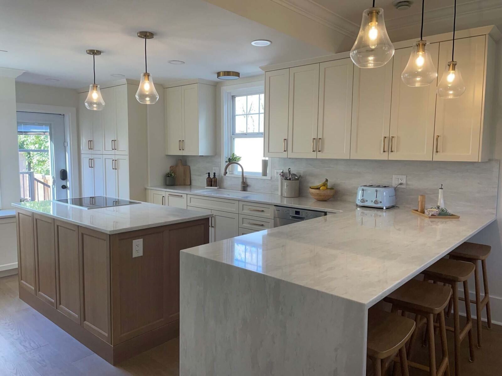 Two-tone kitchen with waterfall island
