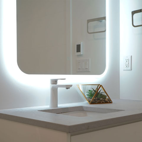 Modern bath sink with a backlit mirror