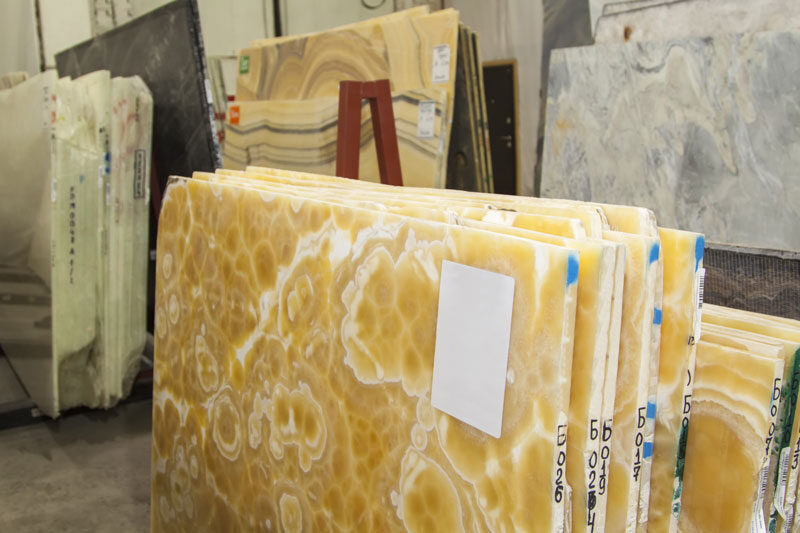 Stacked onyx slabs in warm amber tones