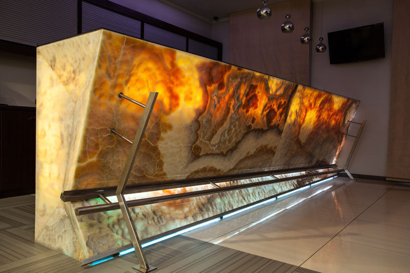 Backlit onyx bar front glowing amber