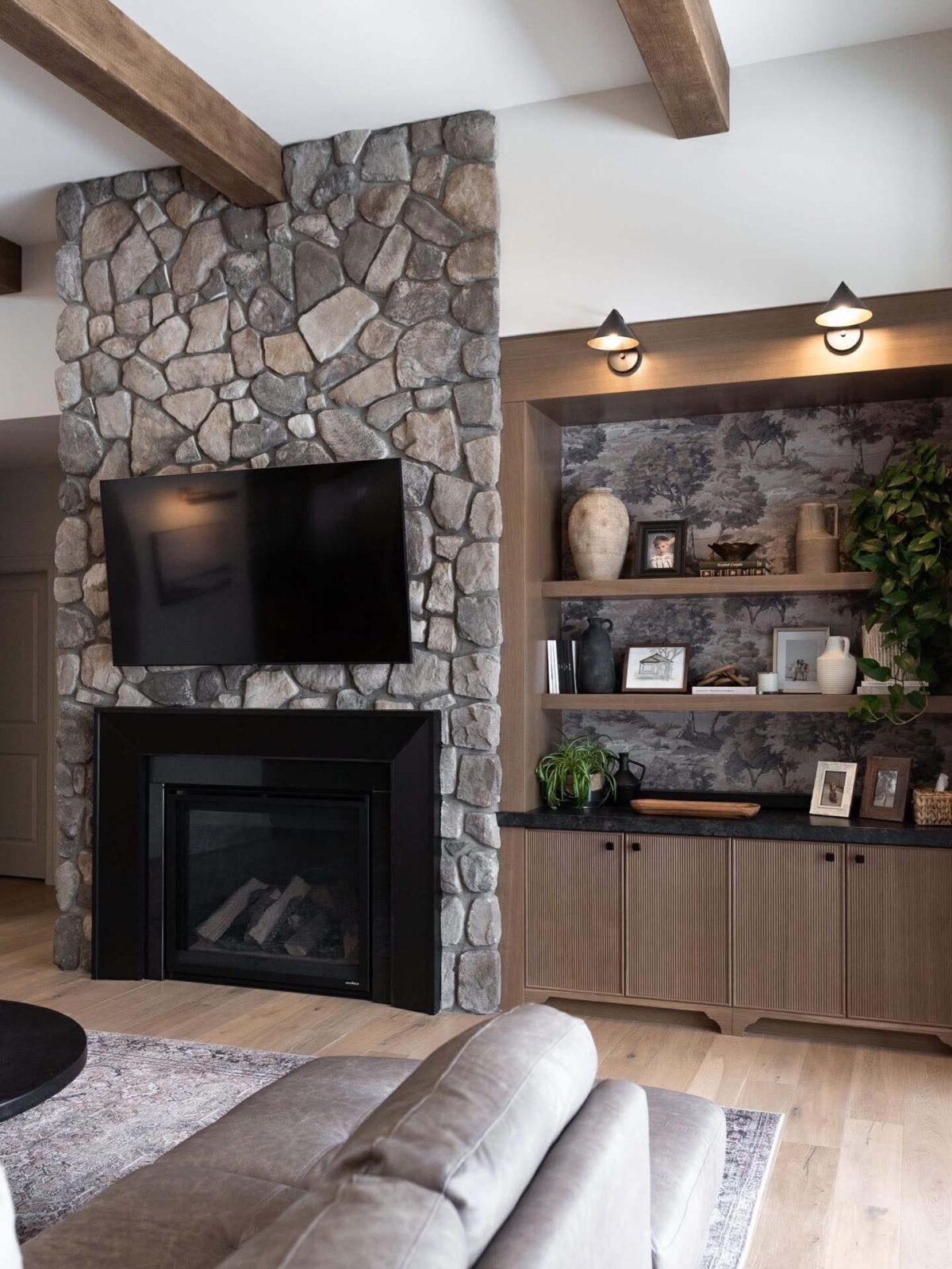 Stone fireplace with built-in cabinetry and shelving