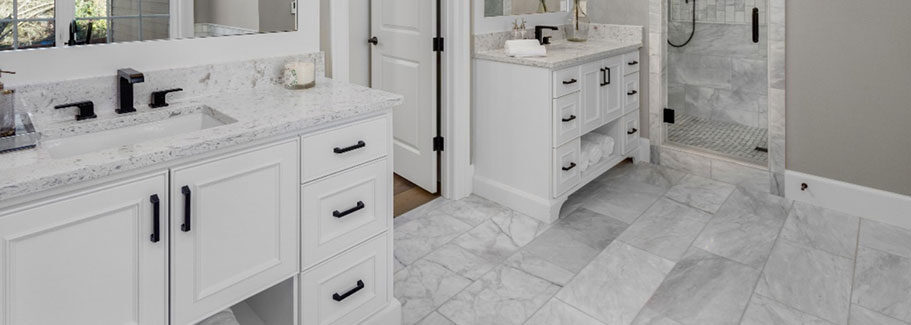 Custom bathroom vanities with stone tops and precise cabinetry