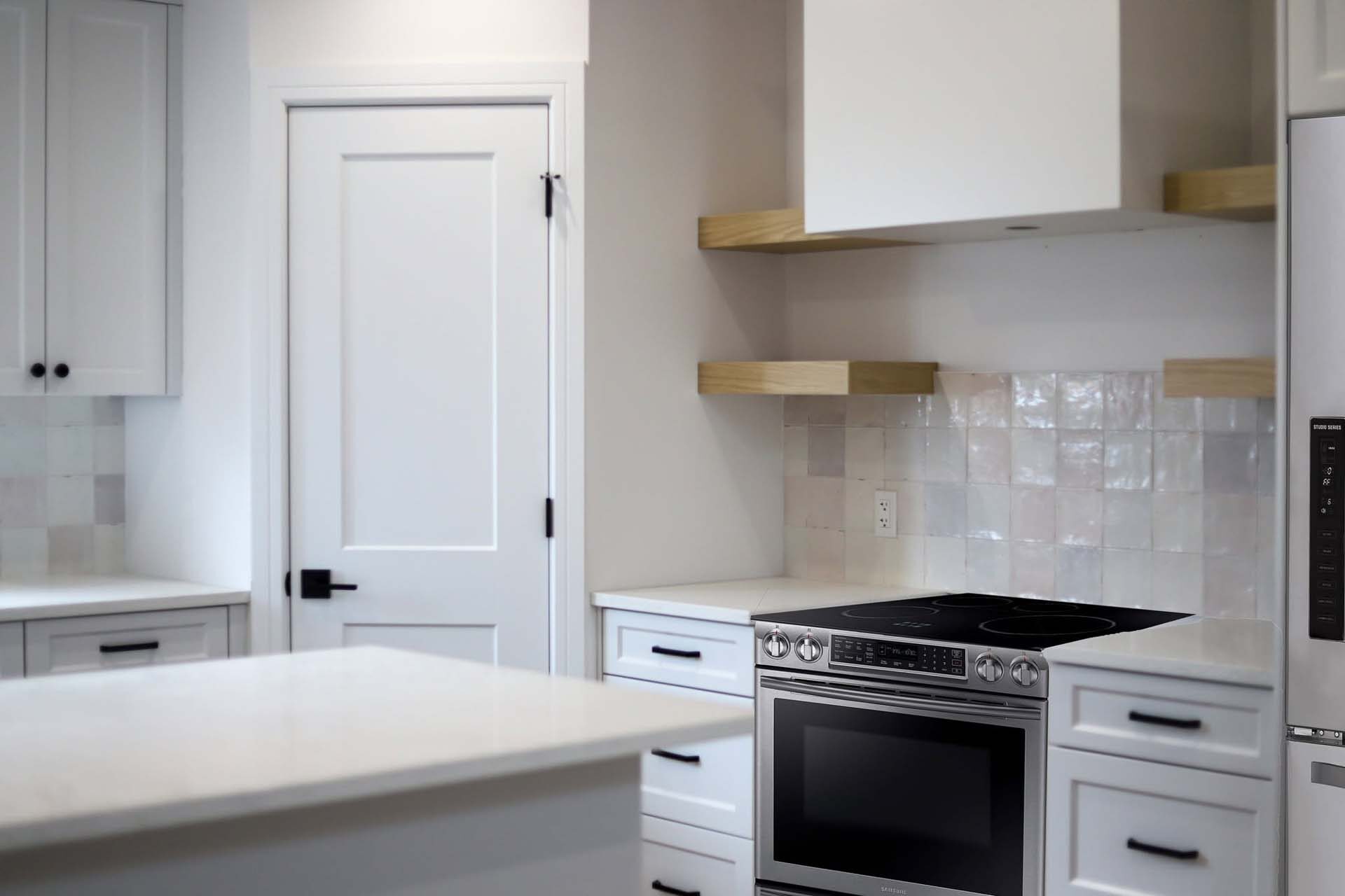 White custom kitchen with wood range hood