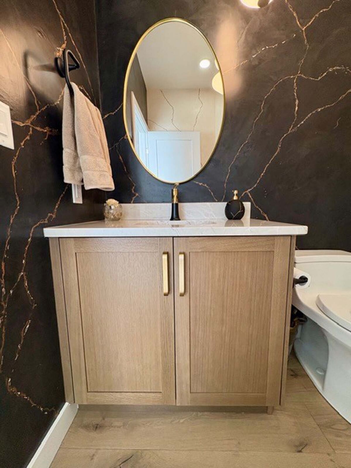 Powder room vanity with brushed gold faucet