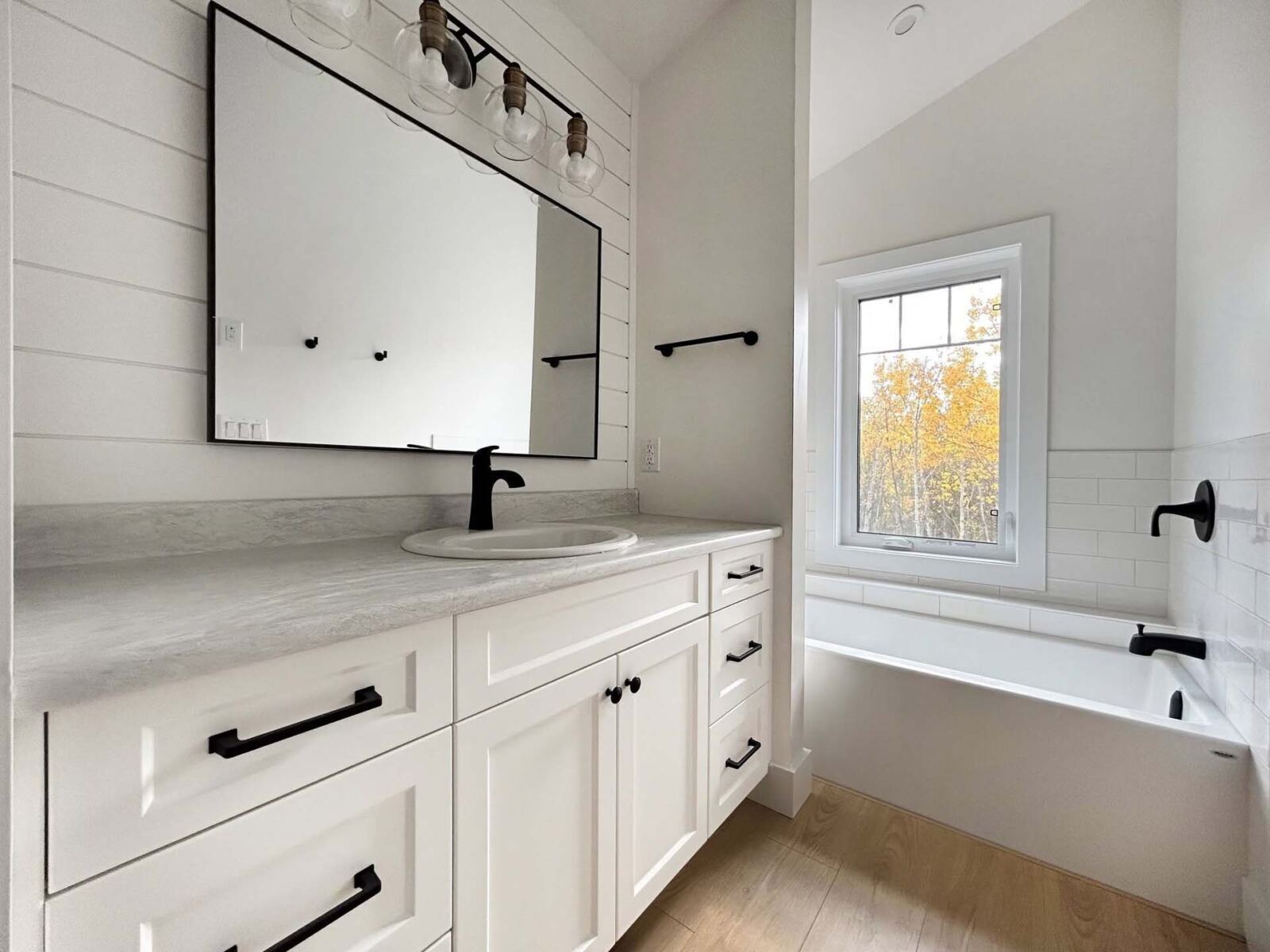 White vanity with black bath faucet
